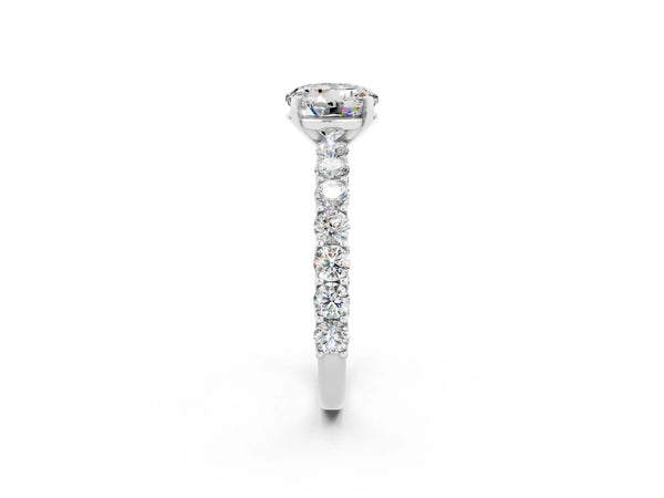 White gold Round Cut Moissanite Solitaire Ring with Shared Prong Pavé Band and Four-Prong Setting
