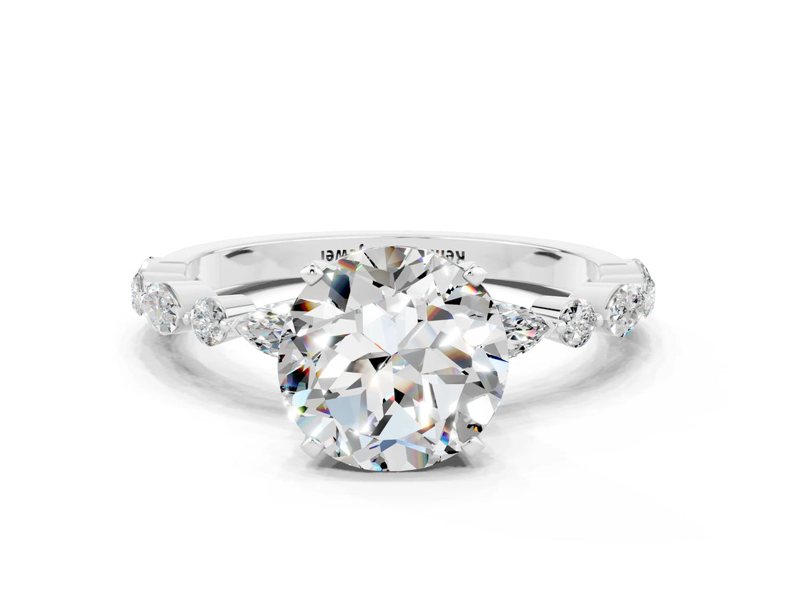 White gold Round Cut Moissanite Solitaire with Side Stones on a Pavé Band and Four-Prong Setting