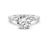 White gold Round Cut Moissanite Solitaire with Side Stones on a Pavé Band and Four-Prong Setting
