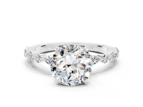 White gold Round Cut Moissanite Solitaire with Side Stones on a Pavé Band and Four-Prong Setting
