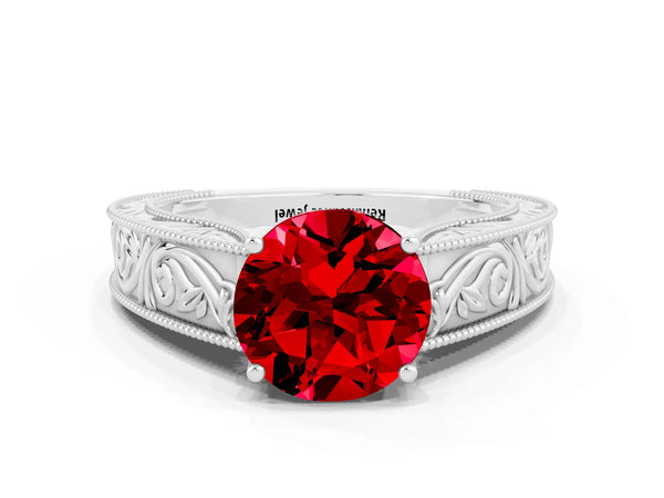 White gold Round Cut Ruby Solitaire Ring with Engraved Band and Four-Prong Setting