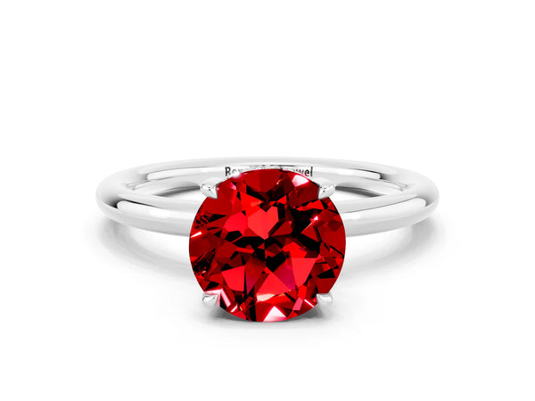Platinum Round Cut Ruby Solitaire Ring with Thin Band and Four-Prong Setting