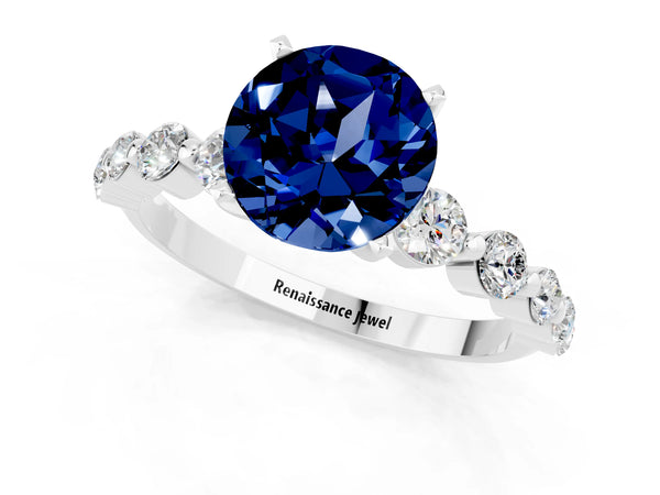 Silver Round Cut Solitaire Blue Sapphire Ring with Pave Band and Four-Prong Setting