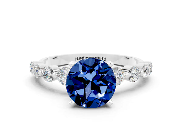 Silver Round Cut Solitaire Blue Sapphire Ring with Pave Band and Four-Prong Setting