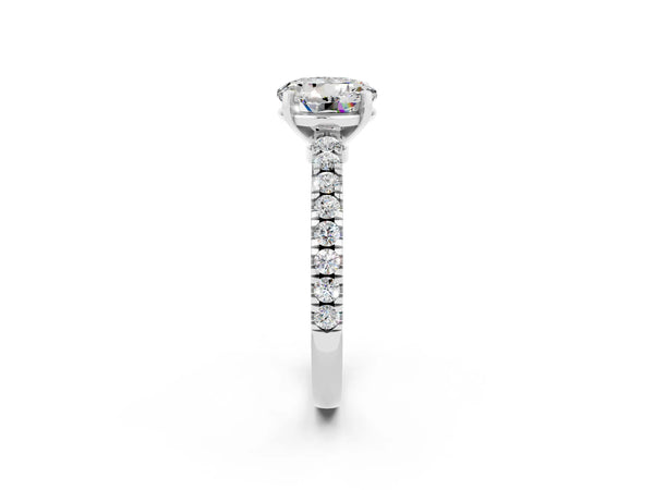 Platinum Round Cut Solitaire Moissanite with Pavé Band and Four-Prong Setting