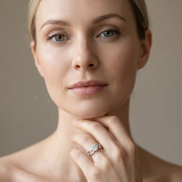 White gold Round Cut Solitaire Diamond with Side Stones on Criss-Cross Band and Four-Prong Setting