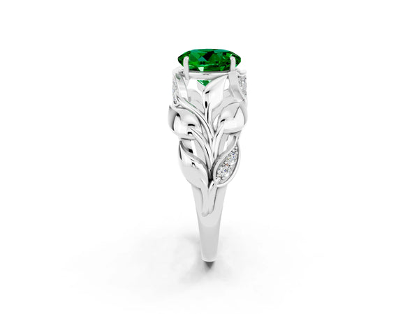 Platinum Round Cut Emerald Leaf-Inspired Engagement Ring with Round Accents and Prong Setting