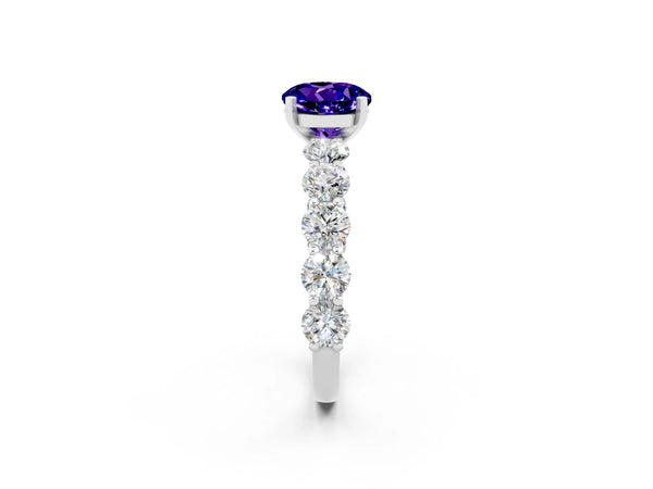 Silver Round Cut Tanzanite Prong Setting with Side Stones on a Pave Band