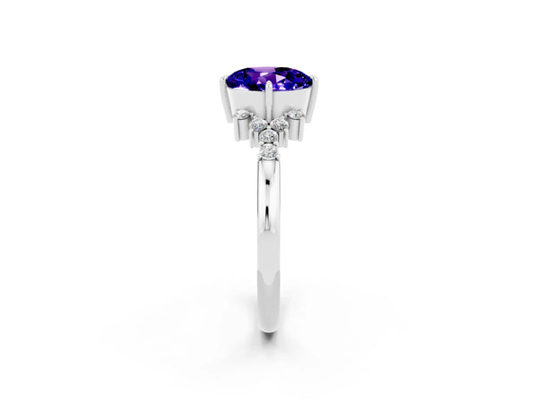 Platinum Round Cut Tanzanite Ring with Side Stones and Four-Prong Setting