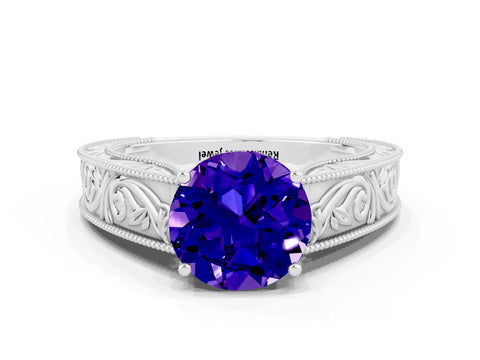 White gold Round Cut Tanzanite Solitaire Ring with Engraved Band and Four-Prong Setting