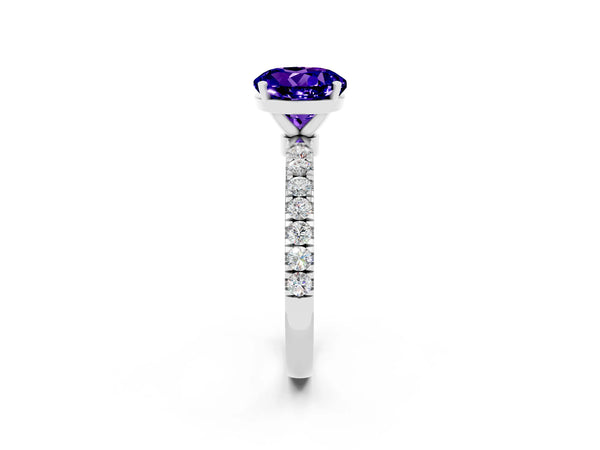 Silver Round Cut Tanzanite Solitaire Ring with Pavé Accents and Four-Prong Setting