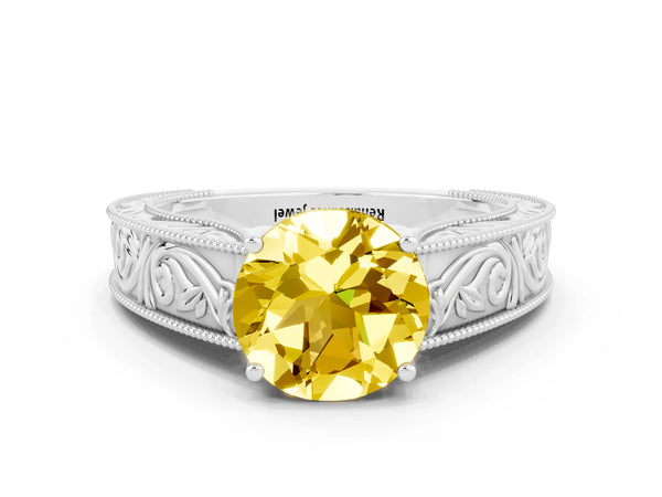 White gold Round Cut Yellow Sapphire Solitaire Ring with Engraved Band and Four-Prong Setting