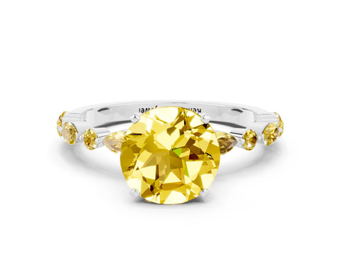 White gold Round Cut Yellow Sapphire Solitaire with Side Stones on a Pavé Band and Four-Prong Setting