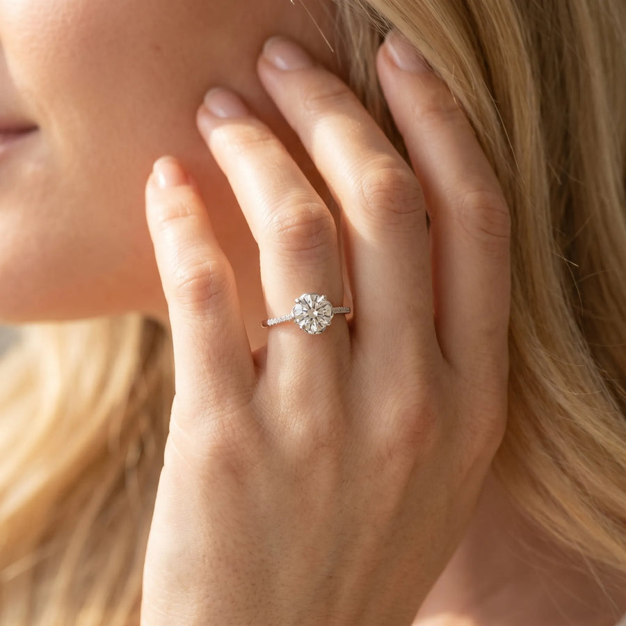 White gold Round Diamond Solitaire Ring with Pavé Accent Band and Four-Prong Setting