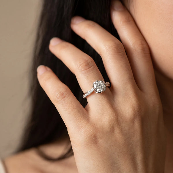 White gold Round Diamond Solitaire Ring with Pavé Band and Sculpted Prong Setting