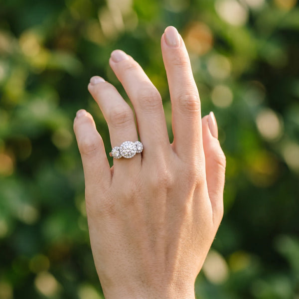White gold Round Diamond Three-Stone Halo Ring with Prong Setting and Pavé Accents