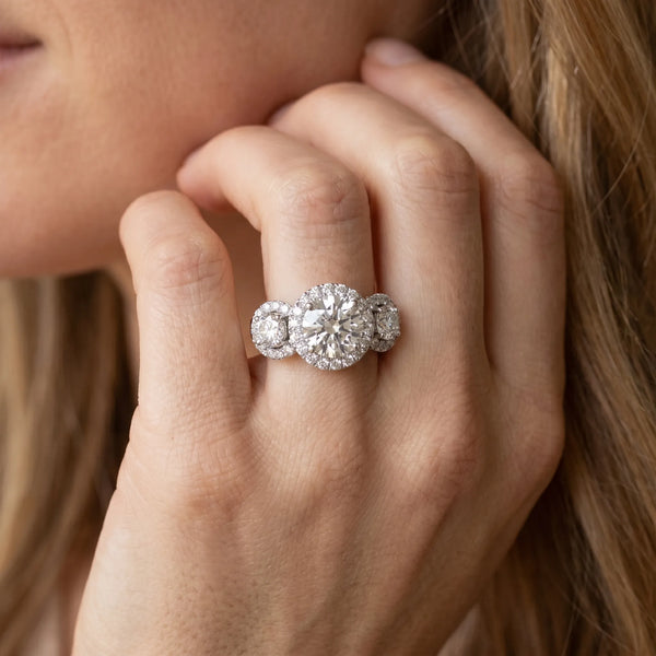 White gold Marquise Cut Diamond Three-Stone Halo Ring with Prong Setting and Pavé Accents
