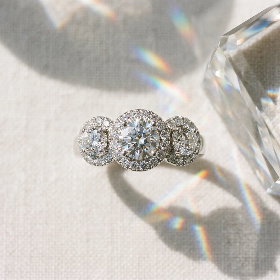 White gold Round Diamond Three-Stone Halo Ring with Prong Setting and Pavé Accents