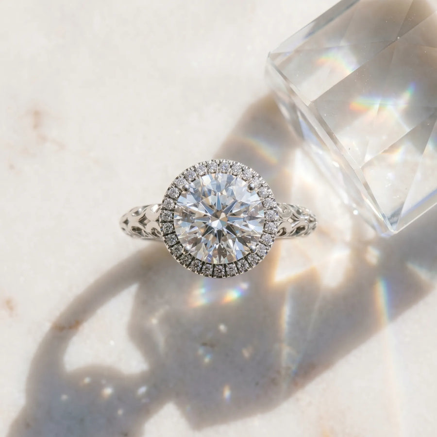 White gold Round Halo Diamond Engagement Ring with Intricate Filigree Band and Four-Prong Setting