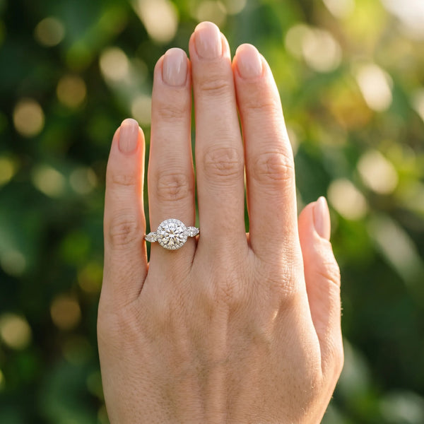 White gold Round Halo Three-Stone Diamond Ring with Pear Side Stones and Four-Prong Setting