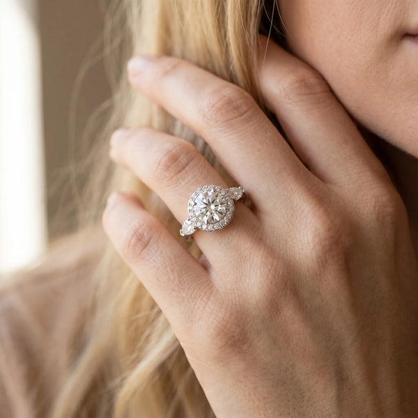 White gold Round Halo Three-Stone Diamond Ring with Pear Side Stones and Four-Prong Setting