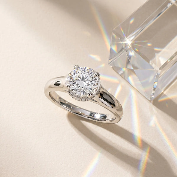 White gold Radiant Cut Solitaire Diamond Engagement Ring with Four-Prong Setting and Tapered Band