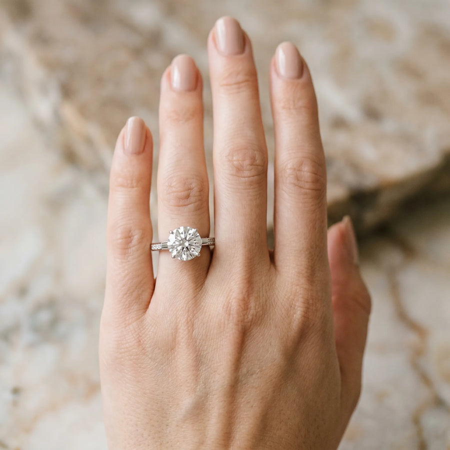 White gold Round Solitaire Diamond Ring with Channel Set Band and Bezel Prong Setting