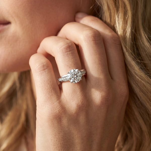 White gold Round Solitaire Diamond Ring with Channel Set Band and Six-Prong Setting