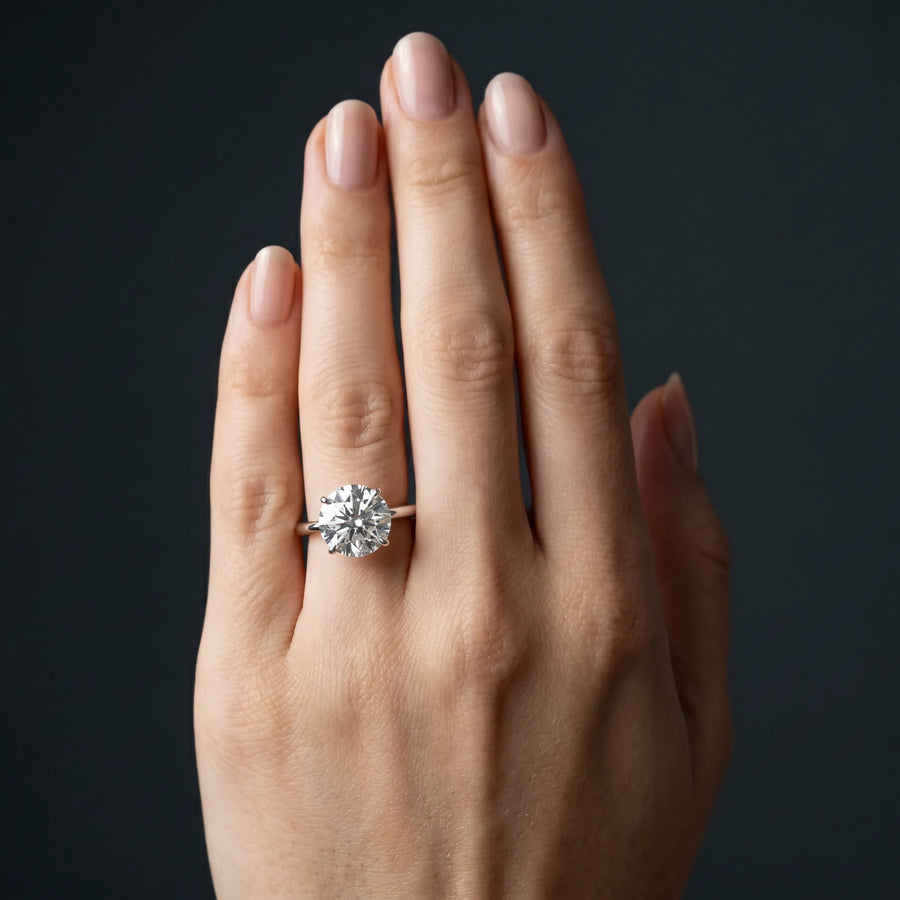 White gold Round Solitaire Diamond Ring with Four-Prong Setting on a Plain Band