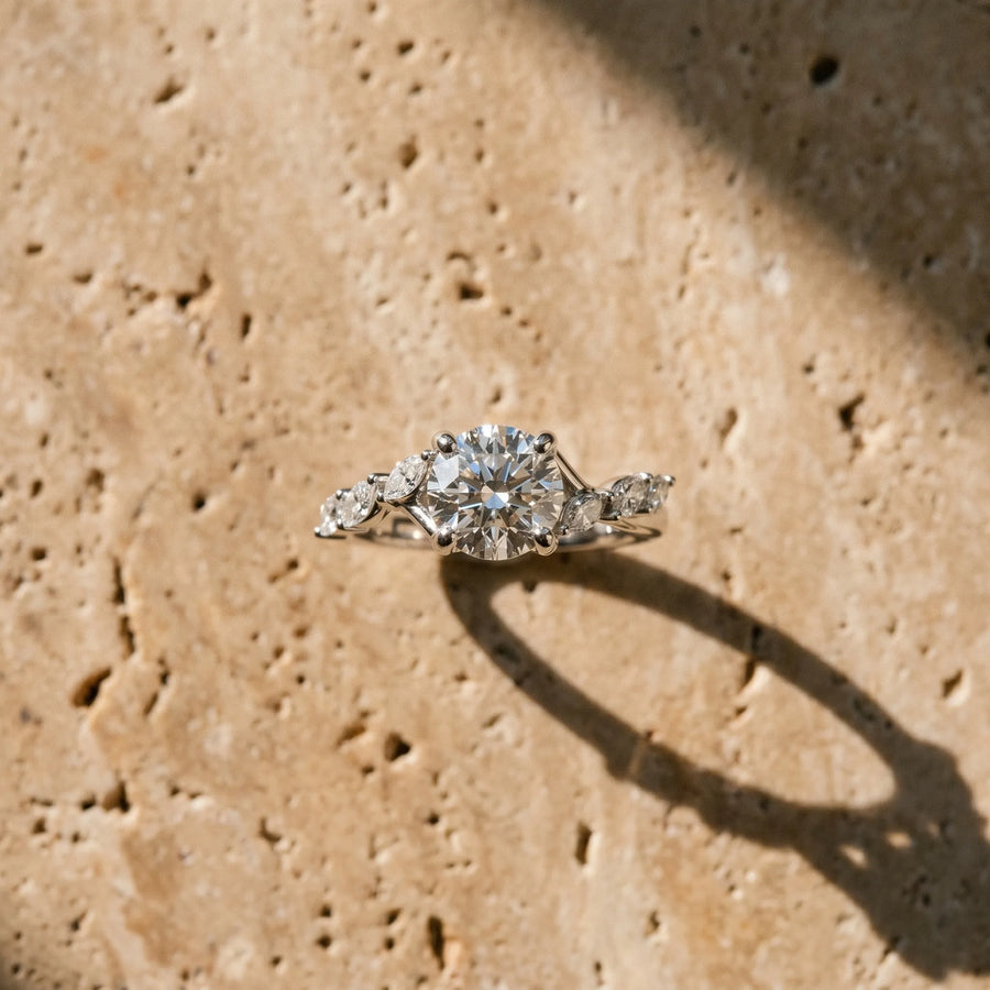White gold Round Solitaire Diamond Ring with Marquise Side Stones and Prong Setting on a Split Shank Band