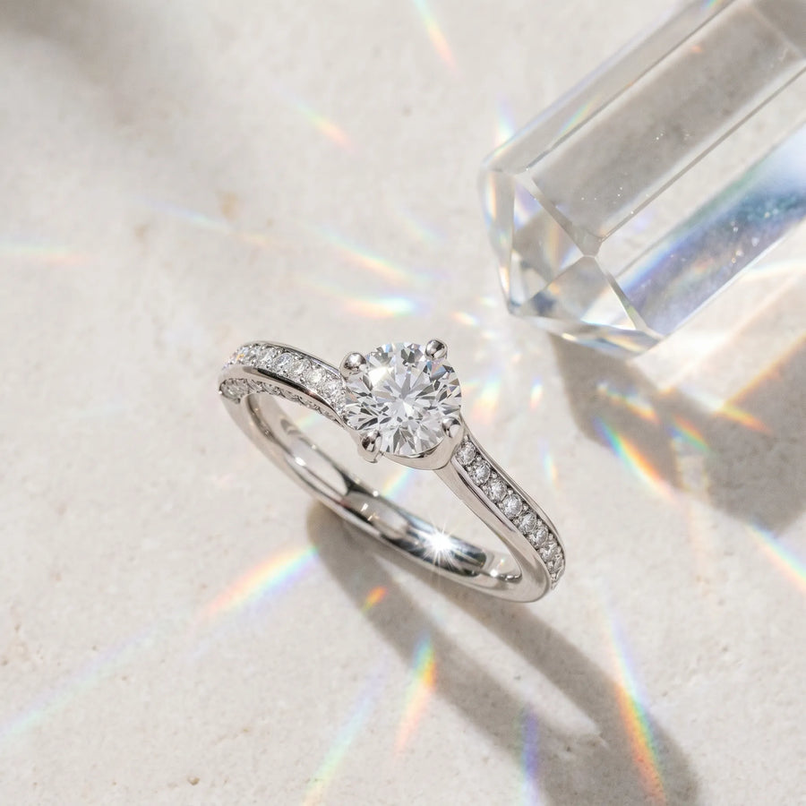 White gold Round Solitaire Diamond Twist Band with Pavé Setting and Four-Prong Setting