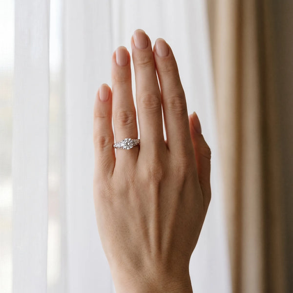 White gold Round Solitaire Scrollwork Engagement Ring with Side Stones and Four-Prong Setting
