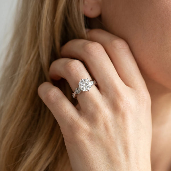 White gold Round Solitaire Twist Band with Leaf Prong Setting