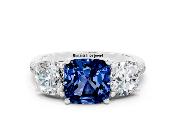 Platinum Three-Stone Cushion Cut Blue Sapphire Ring with Round  Pavé Band and Prong Setting