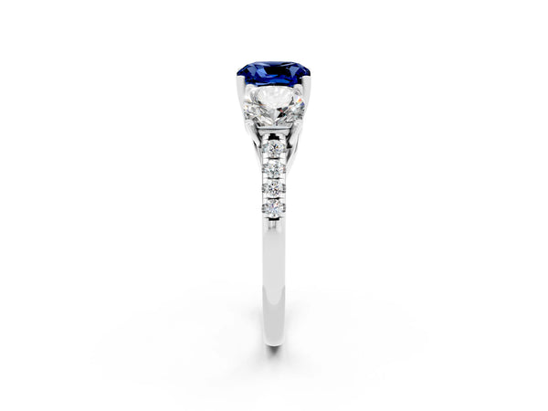 Platinum Three-Stone Cushion Cut Blue Sapphire Ring with Round  Pavé Band and Prong Setting
