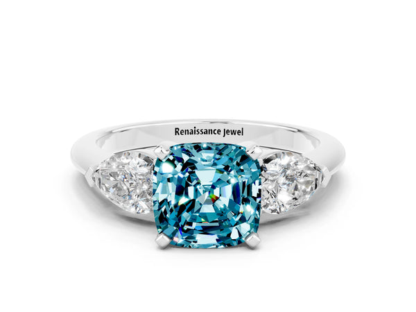 Silver Three-Stone Cushion Cut Blue Topaz Ring with Pear Side Stones and Four-Prong Setting