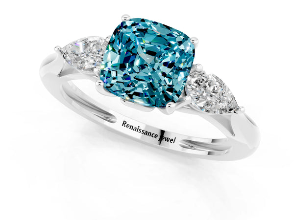 Platinum Three-Stone Cushion Cut Blue Topaz Ring with Pear  Side Stones in Four-Prong Setting