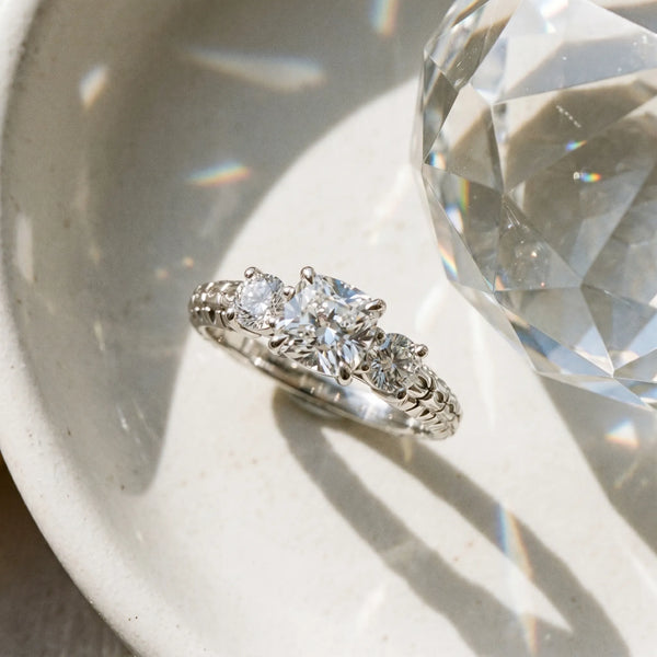White gold Three-Stone Cushion Cut Diamond Ring with Channel-Set Band and Prong Setting
