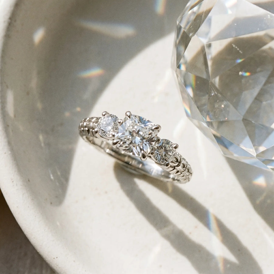 White gold Three-Stone Cushion Cut Diamond Ring with Channel-Set Band and Prong Setting