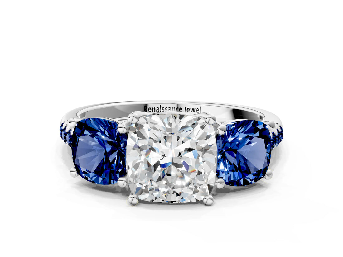 White gold Three-Stone Cushion Cut Diamond Ring with Round with Blue Sapphire side stone Pavé Band and Prong Setting