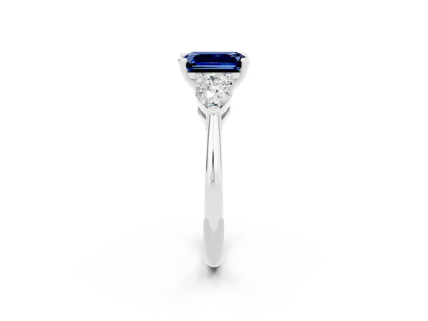 Platinum Three-Stone Emerald Cut Blue Sapphire Ring with Pear Side Stones and Four-Prong Setting