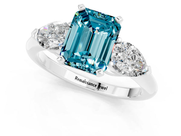 Silver Three-Stone Emerald Cut Blue Topaz Ring with Pear Side Stones and Four-Prong Setting