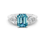 White gold Three-Stone Emerald Cut Blue Topaz Ring with Pear Side Stones and Four-Prong Setting