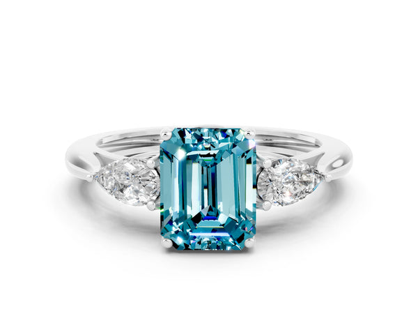 White gold Three-Stone Emerald Cut Blue Topaz Ring with Pear  Side Stones in Four-Prong Setting
