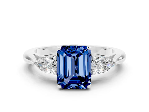 White gold Three-Stone Emerald Cut Cut Diamond Ring with Pear Side Stones in Four-Prong Setting
