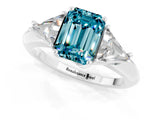 White gold Three-Stone Emerald Cut Cut Diamond Ring with Trillion Side Stones and Four-Prong Setting_1