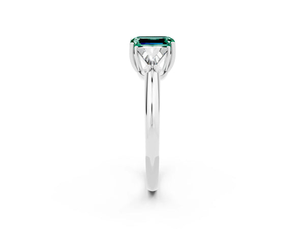 Silver Three-Stone Emerald Cut Green Sapphire Engagement Ring with Trillion Side Stones and Prong Setting