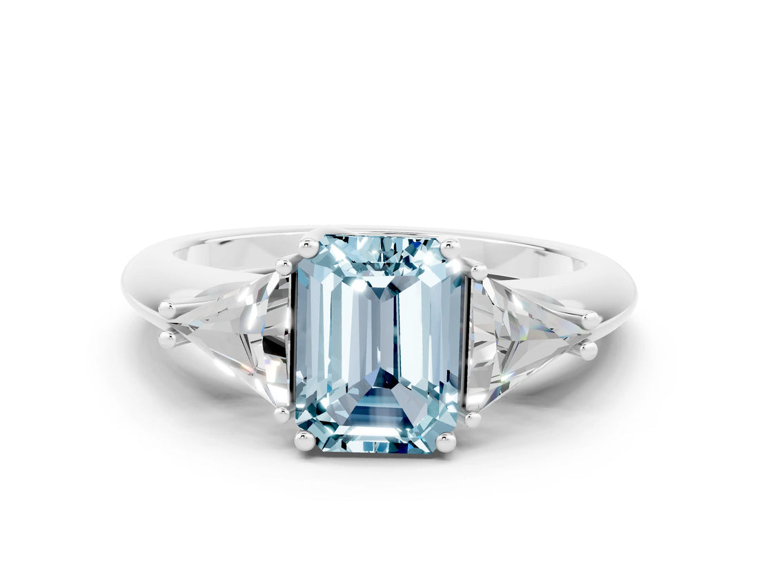 White gold Three-Stone Emerald Cut Cut Diamond Ring with Trillion Side Stones and Four-Prong Setting