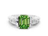 White gold Three-Stone Emerald Cut Cut Diamond Ring with Trillion Side Stones and Four-Prong Setting
