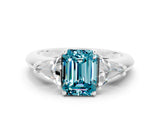 White gold Three-Stone Emerald Cut Cut Diamond Ring with Trillion Side Stones and Four-Prong Setting